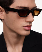 10 Core Brown Sunglasses worn by a model, featuring stylish design and high-quality lenses for UV protection.