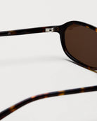 Close-up view of Edith Tortoise Sunglasses showcasing the frame and anti-scratch lenses.