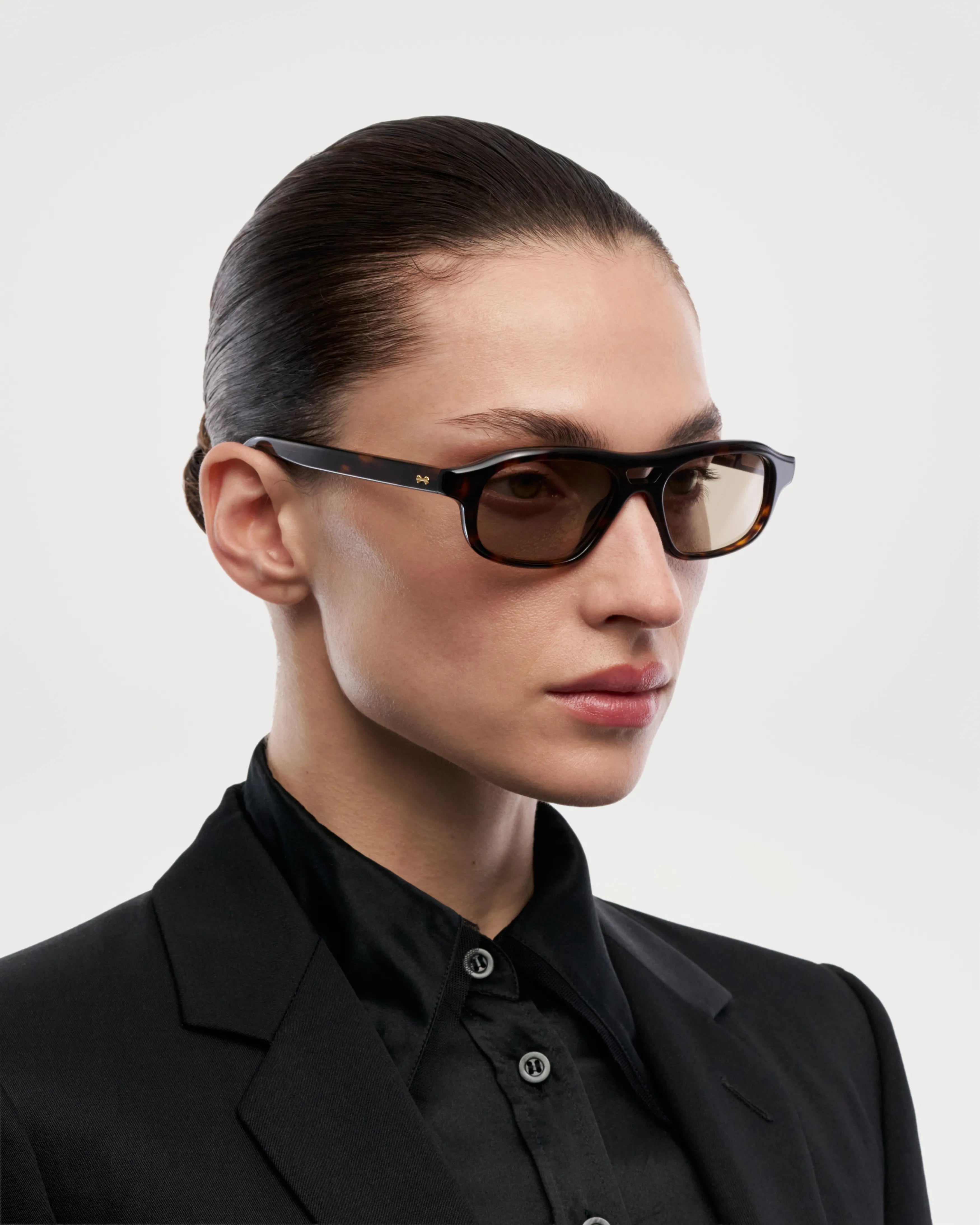 Eli Terra Tortoise Sunglasses modeled by a woman, showcasing stylish design and high-quality eyewear.