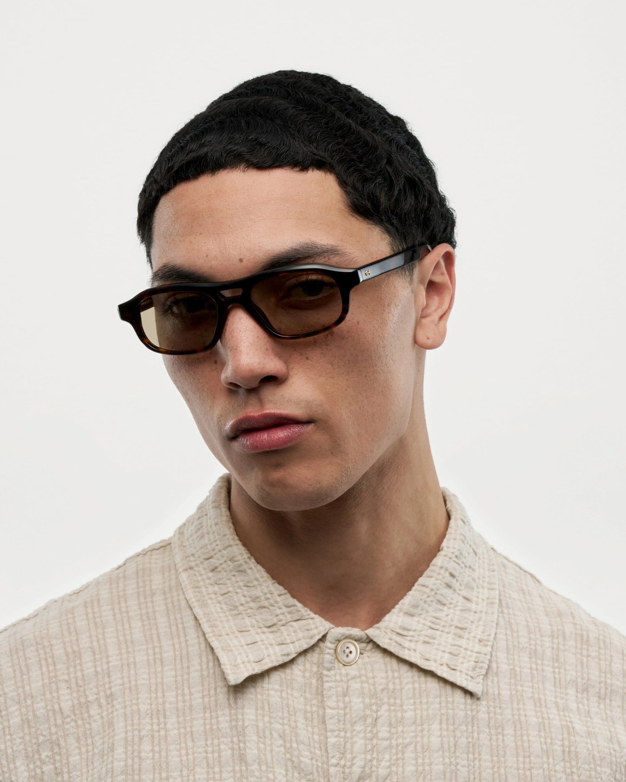 Eli Terra Tortoise Sunglasses worn by a model, showcasing high-quality design and style.