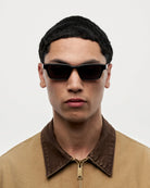 Model wearing Kasi Black Sunglasses, showcasing stylish black design and modern aesthetic.