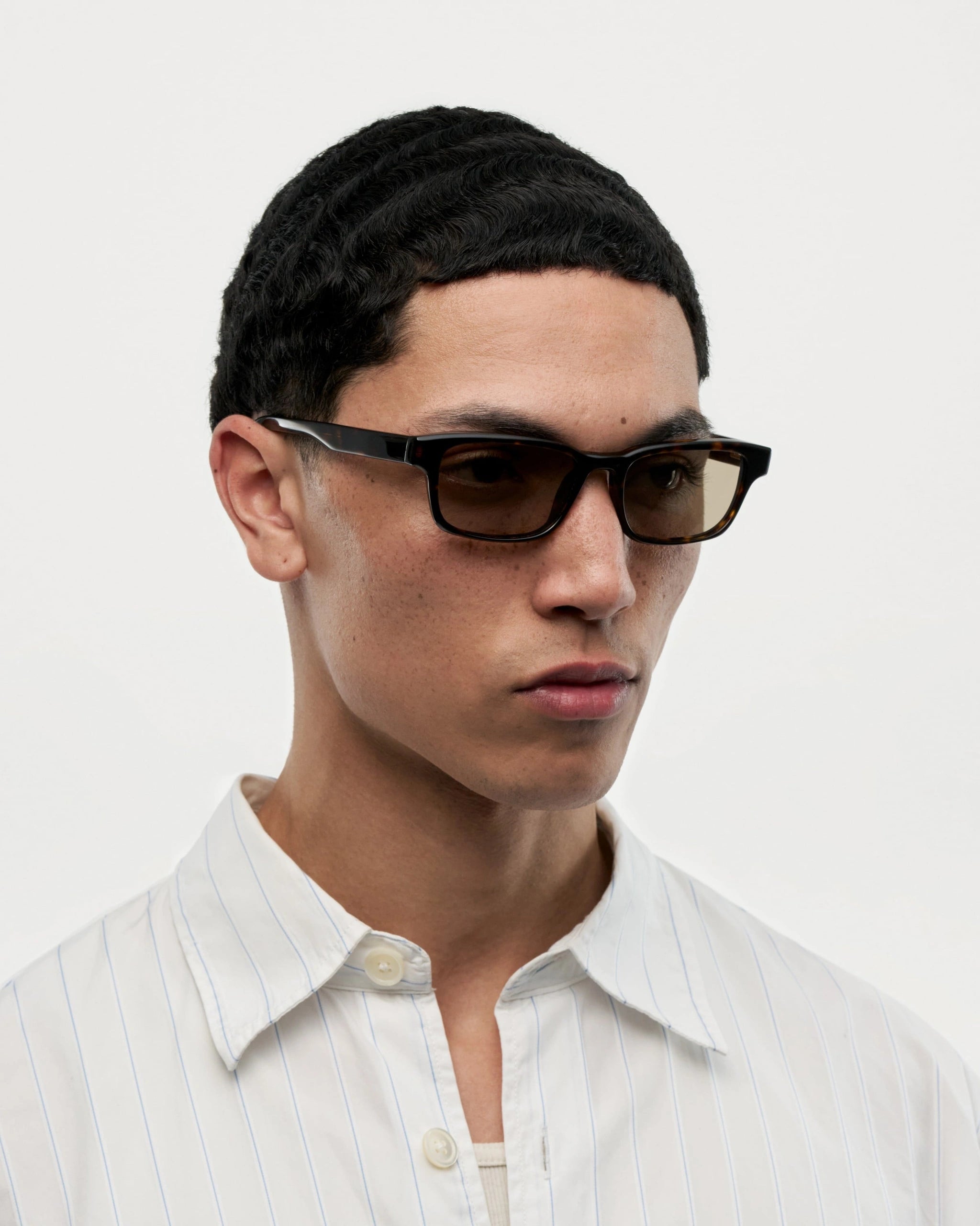 Kasi Terra Tortoise Sunglasses worn by a man, showcasing stylish design and high-quality UV protection.