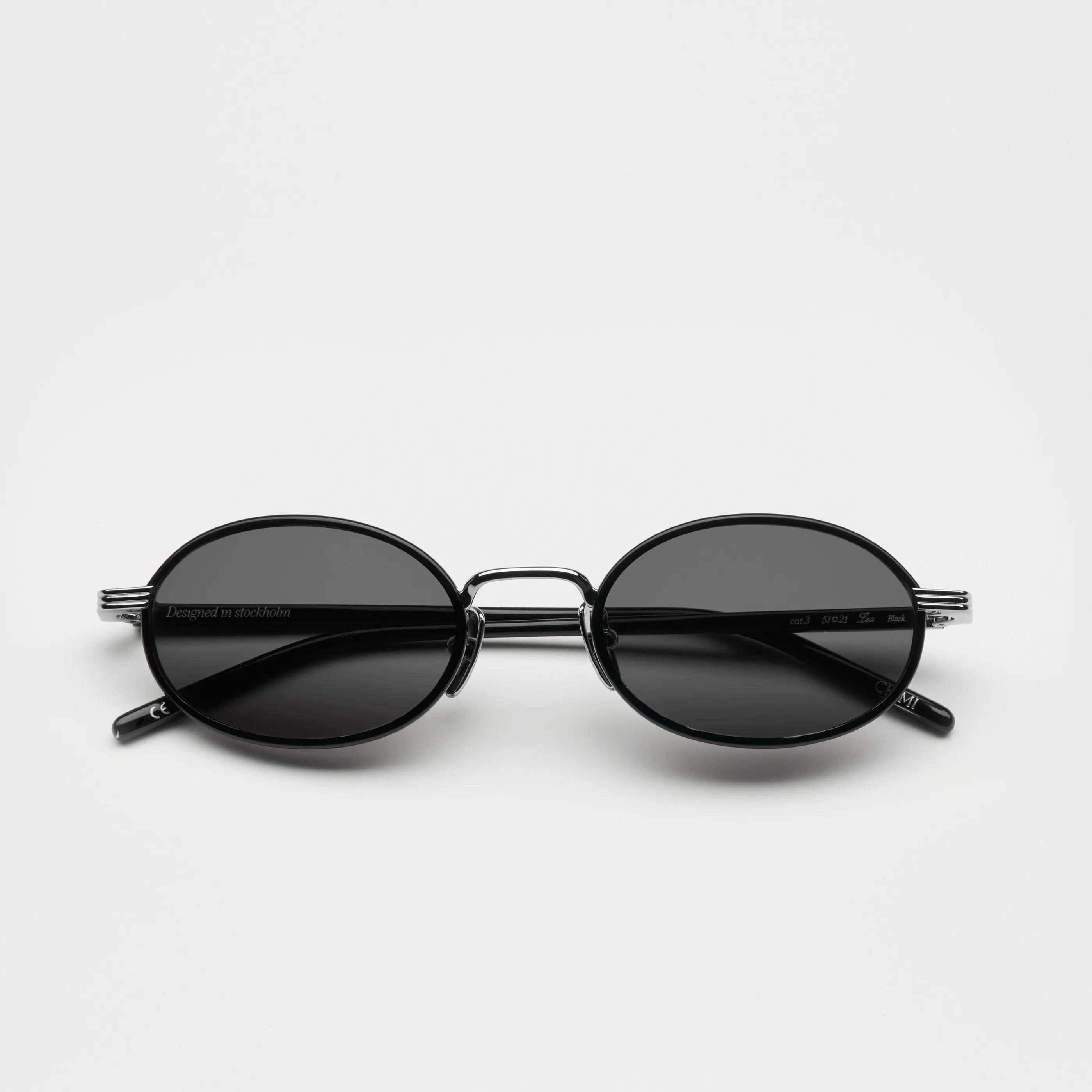 Lea Black Sunglasses positioned against a white background, showcasing its high-quality design and lenses.