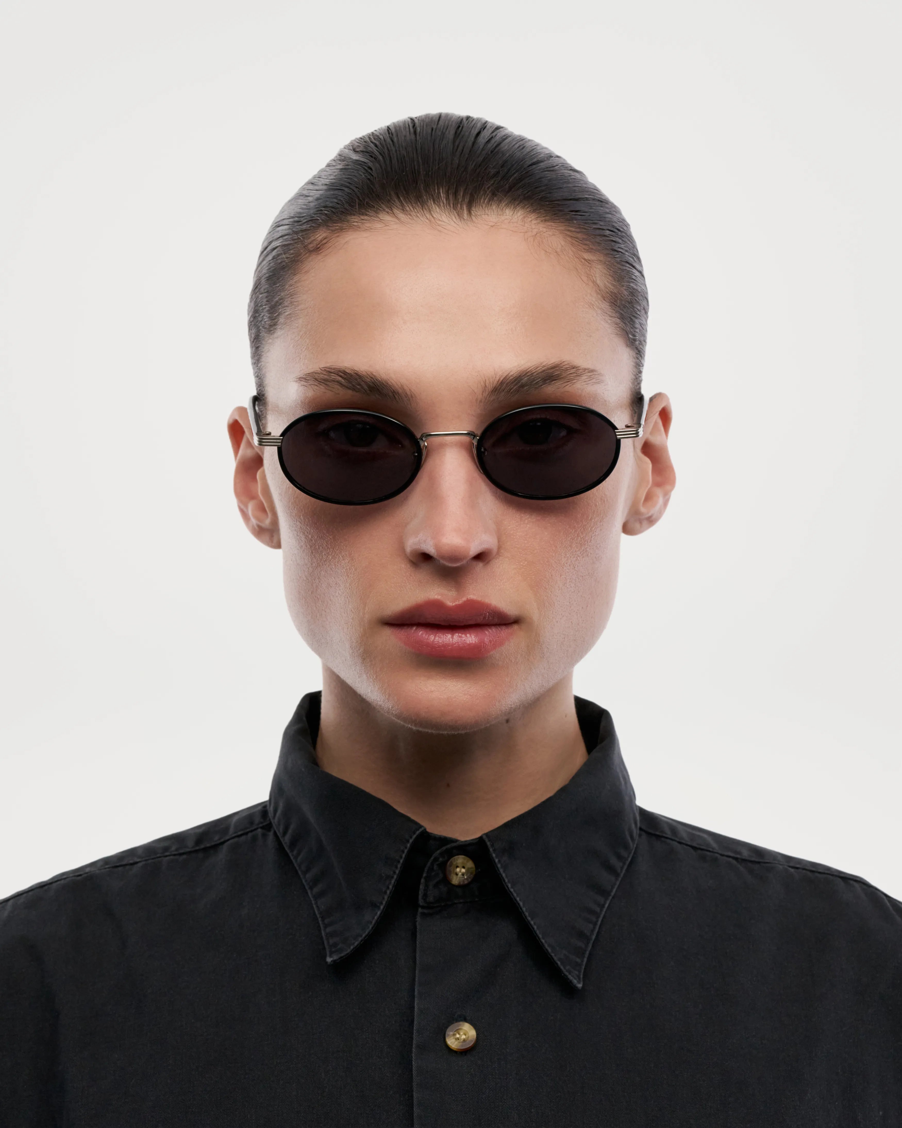 Model wearing Lea Black Sunglasses, featuring durable Acetate Renew™ and anti-scratch lenses for stylish sun protection.