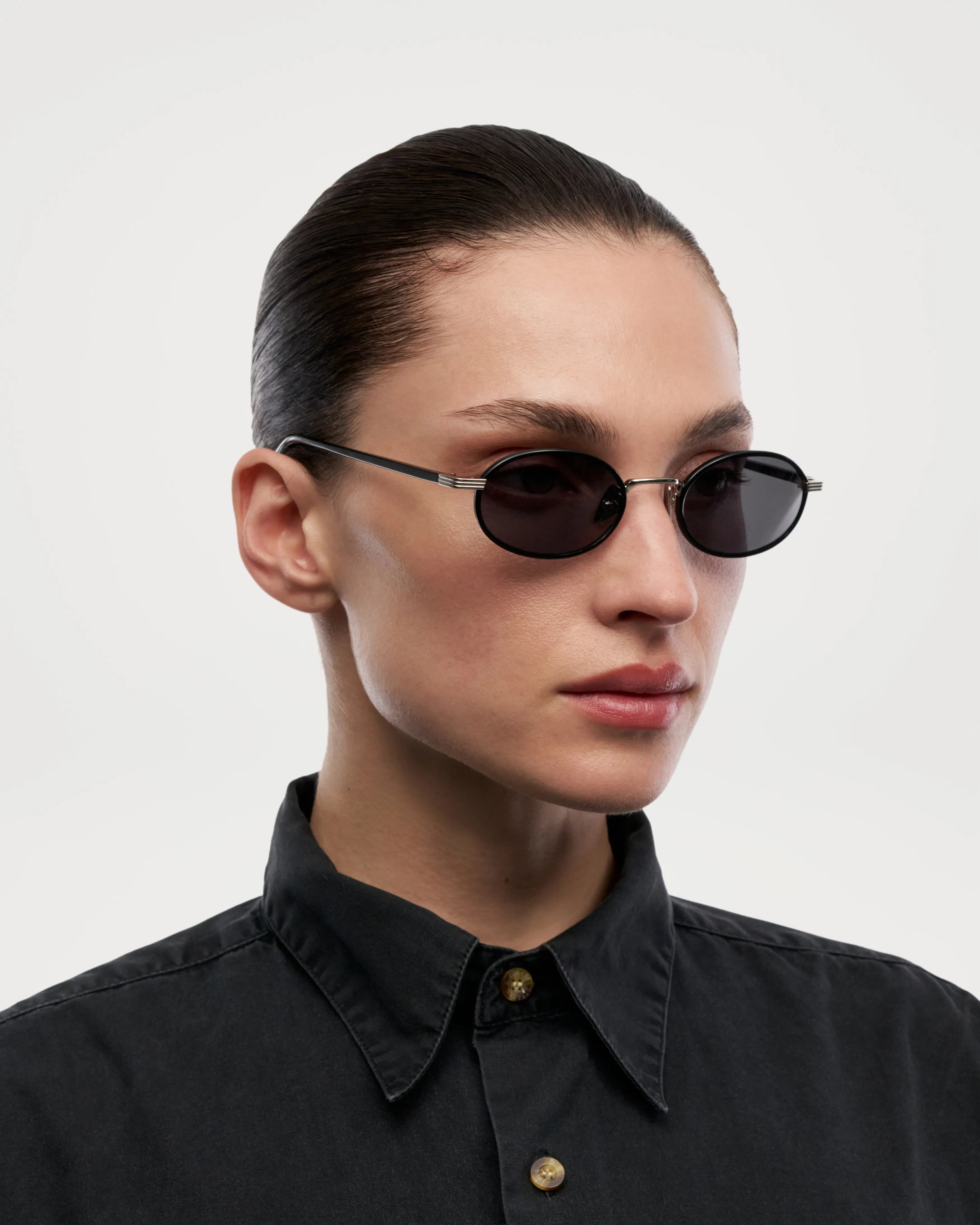 Model wearing Lea Black Sunglasses, showcasing sleek design and high-quality materials.