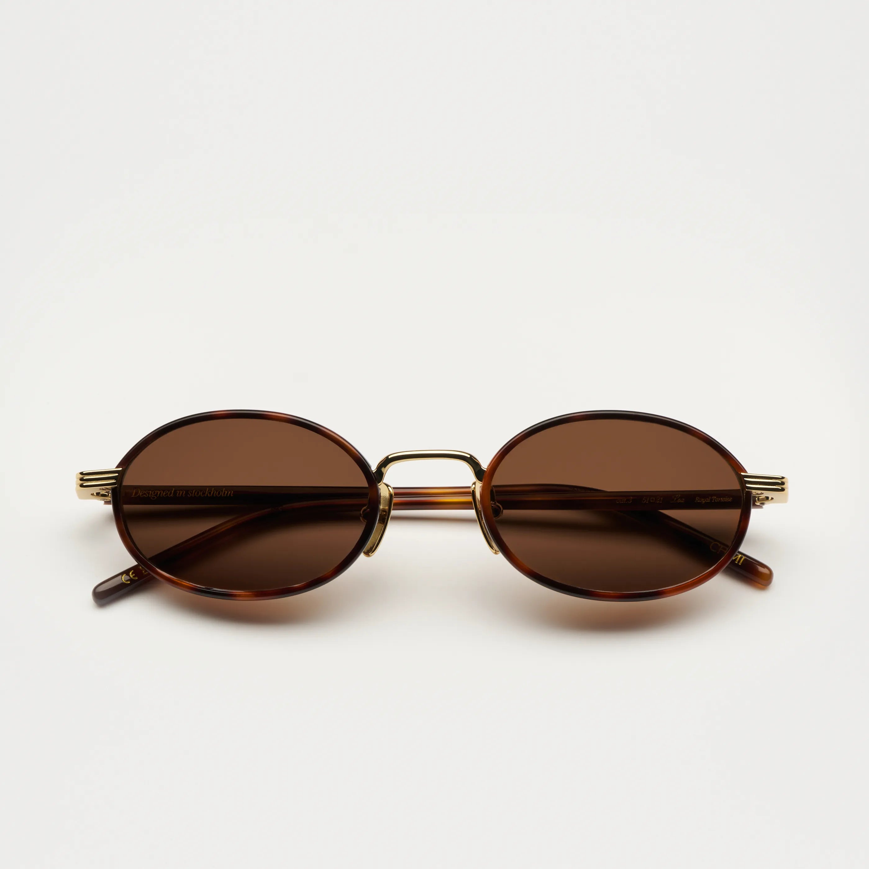Lea Royal Tortoise Sunglasses with brown lenses and gold details on a white background.