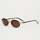 Lea Royal Tortoise Sunglasses with brown lenses and gold details, offering 100% UVA + UVB protection.