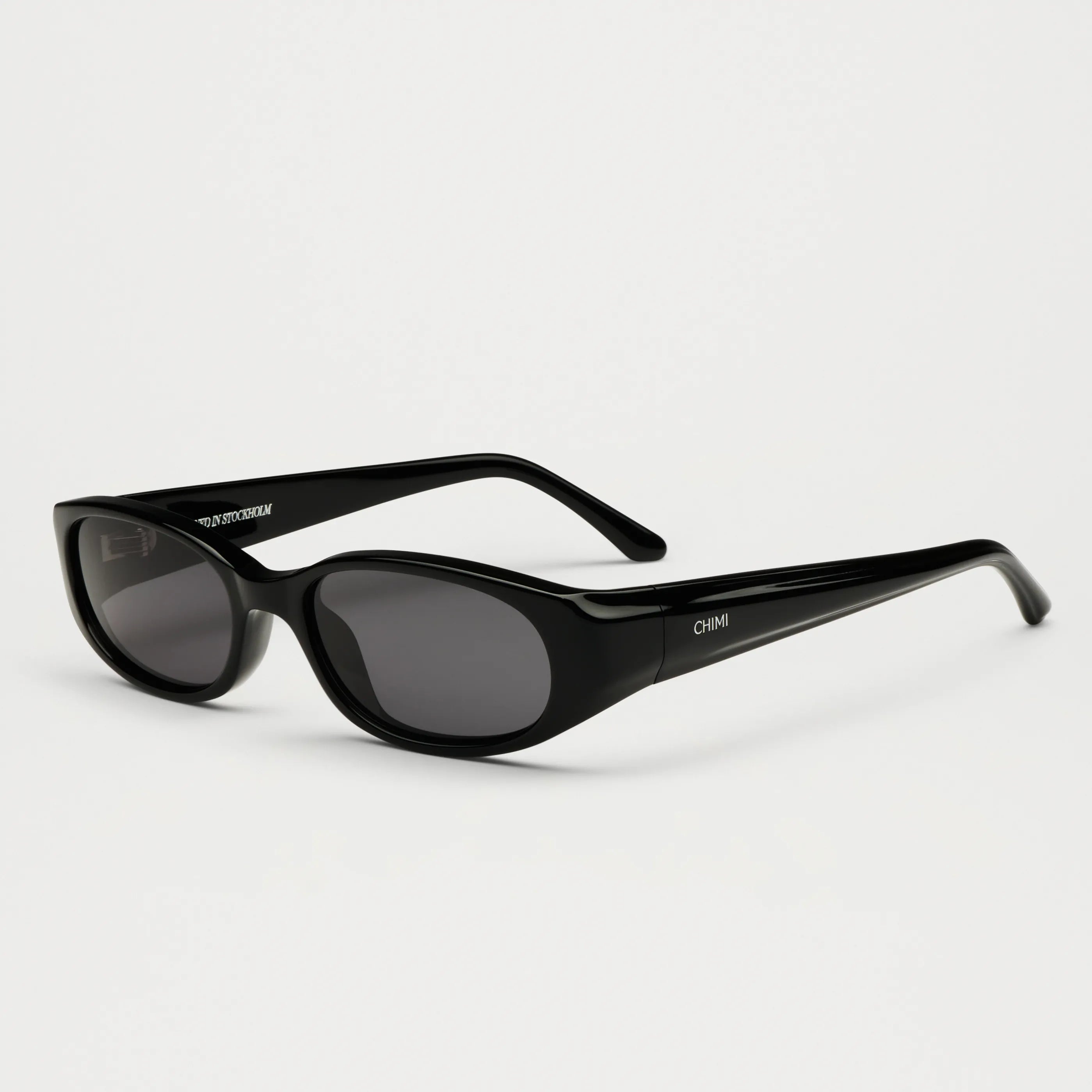 Note Black Sunglasses with stylish black frames and dark lenses, ideal for small to medium heads, includes case and cleaning cloth.