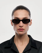 Note Black Sunglasses worn by a model, showcasing stylish design and 100% UVA + UVB protection.