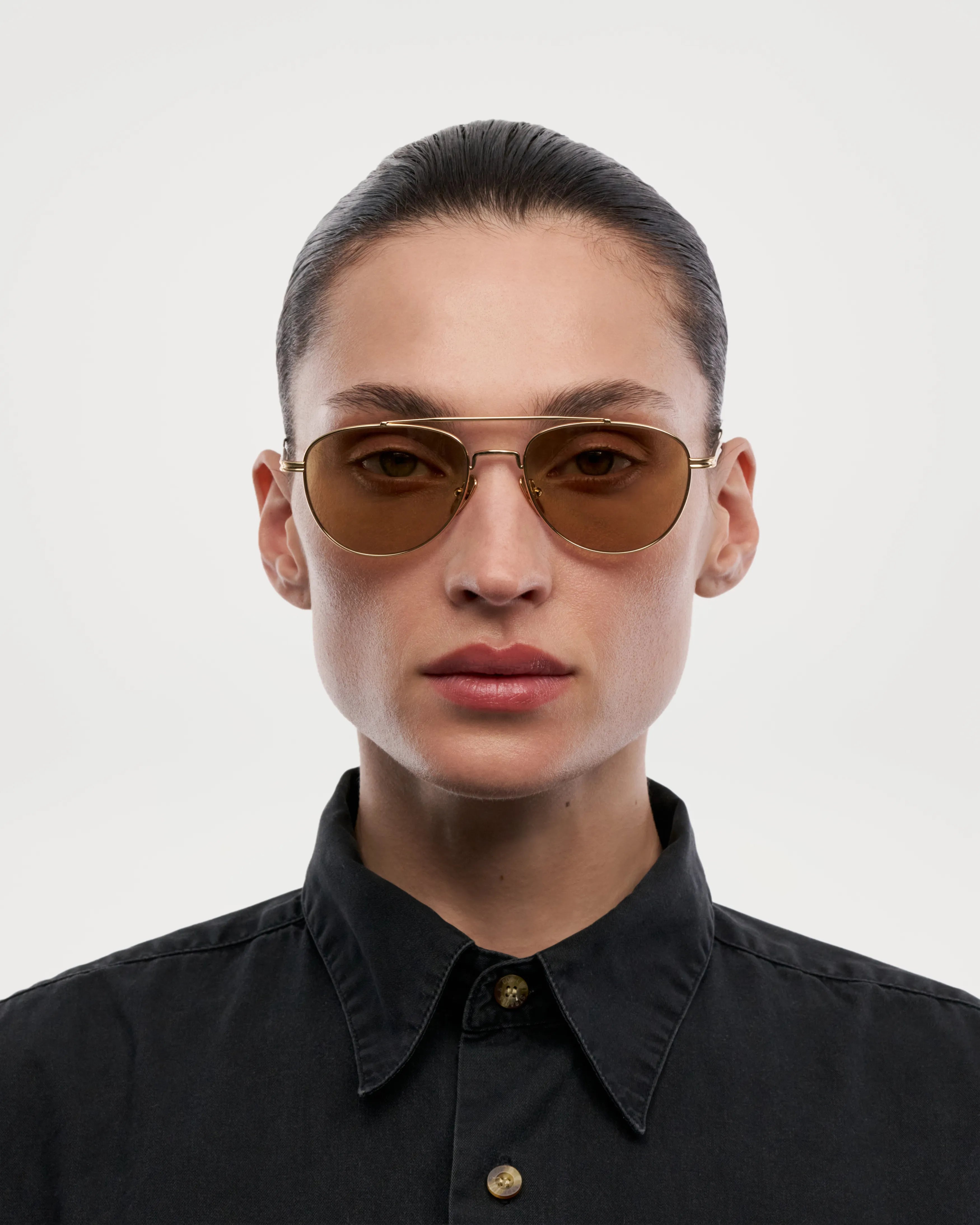 Pantos Gold Sunglasses worn by a model, showcasing the stylish design with brown lenses and unisex appeal.