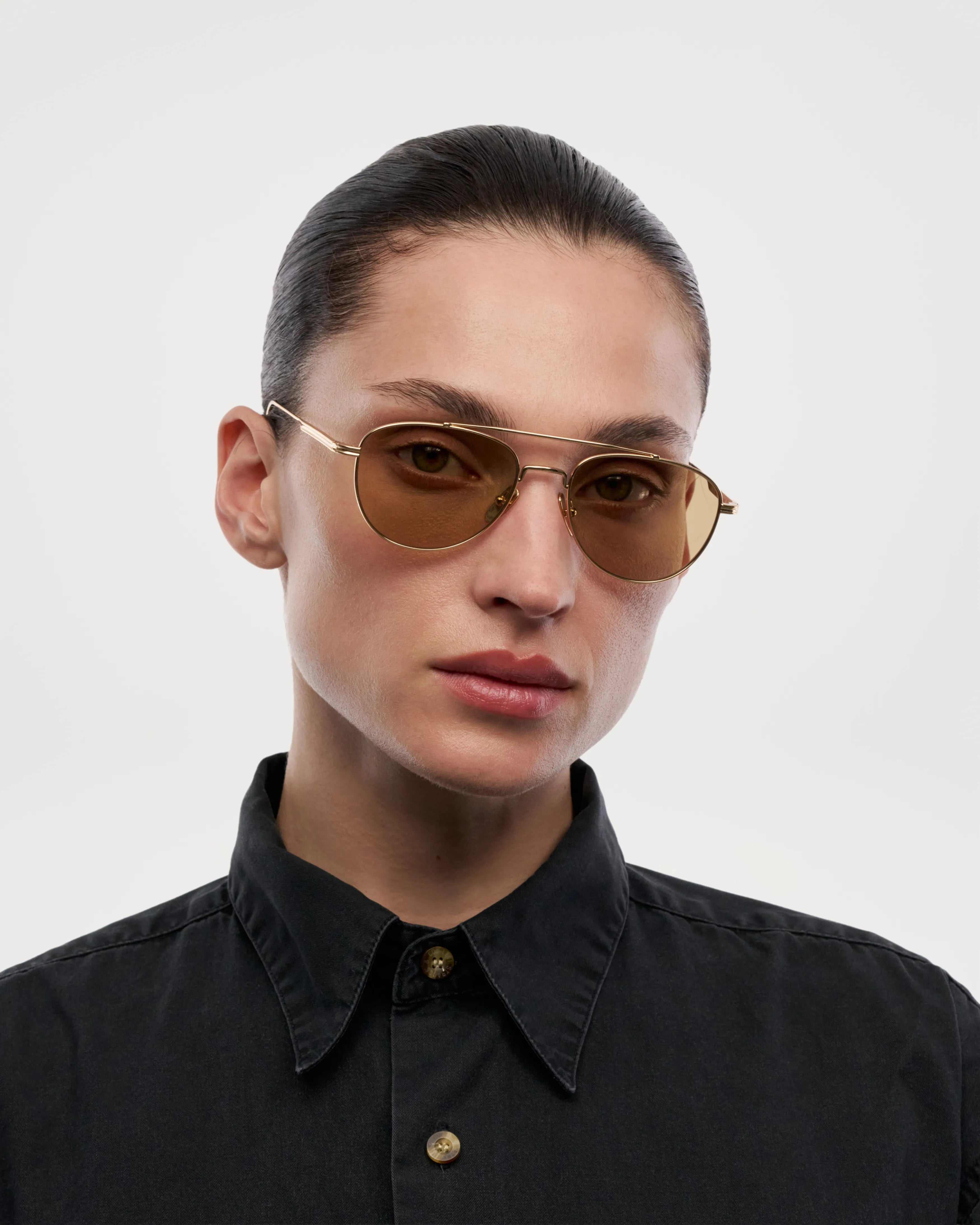 Pantos Gold Sunglasses worn by a model, showcasing the unisex design and UV protection features.