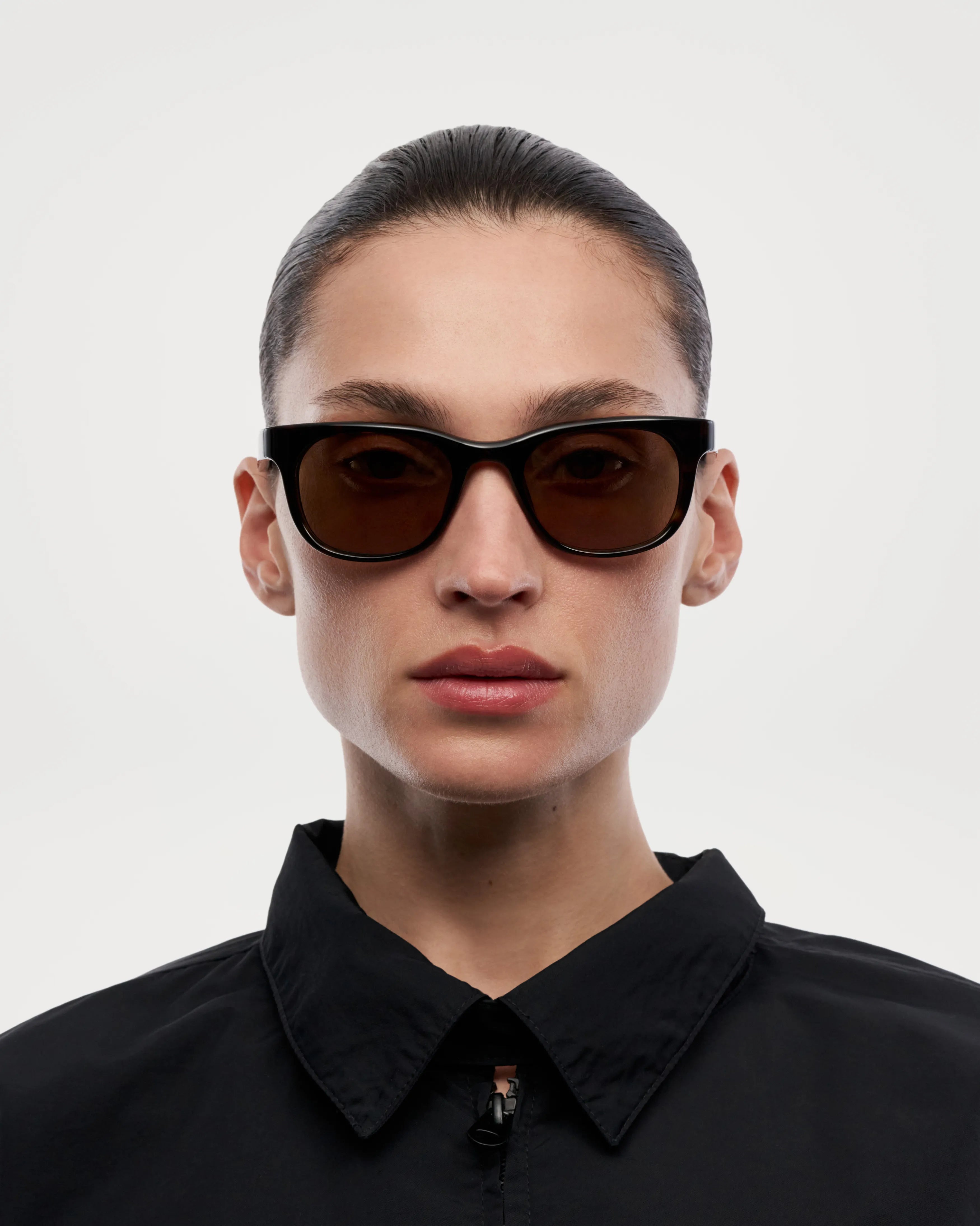 Woman wearing Savy Tortoise Sunglasses, featuring dark lenses and stylish frame, perfect for UVA and UVB protection.