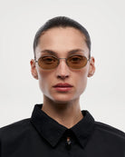 Oval Silver Sunglasses worn by a model, showcasing a modern design and UV 400 protection, ideal for unisex use.