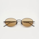 Oval Silver Sunglasses with brown lenses, UV protection, and bio nylon frame against a neutral background.