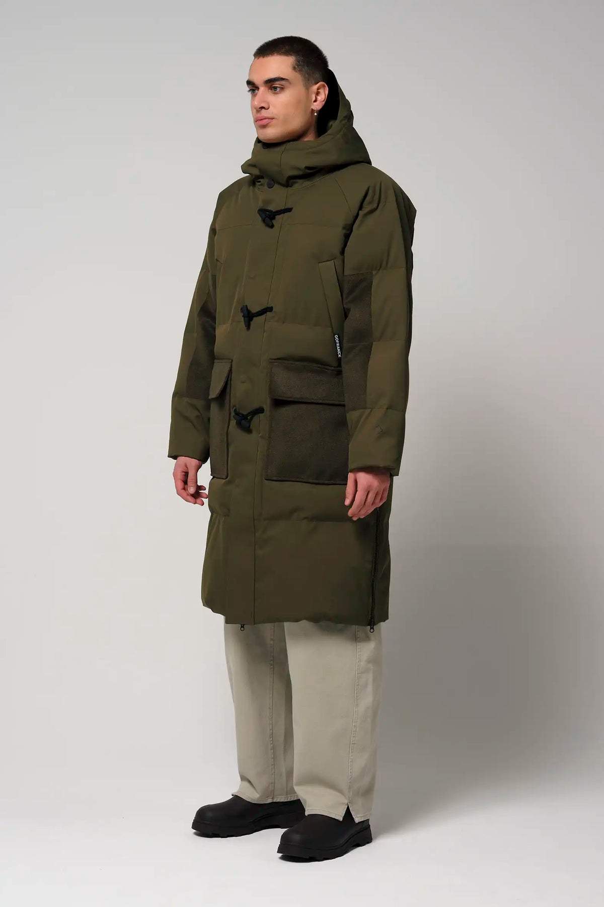 Barack Dark Olive Green Parka worn by a model, featuring multiple pockets and adjustable hood.