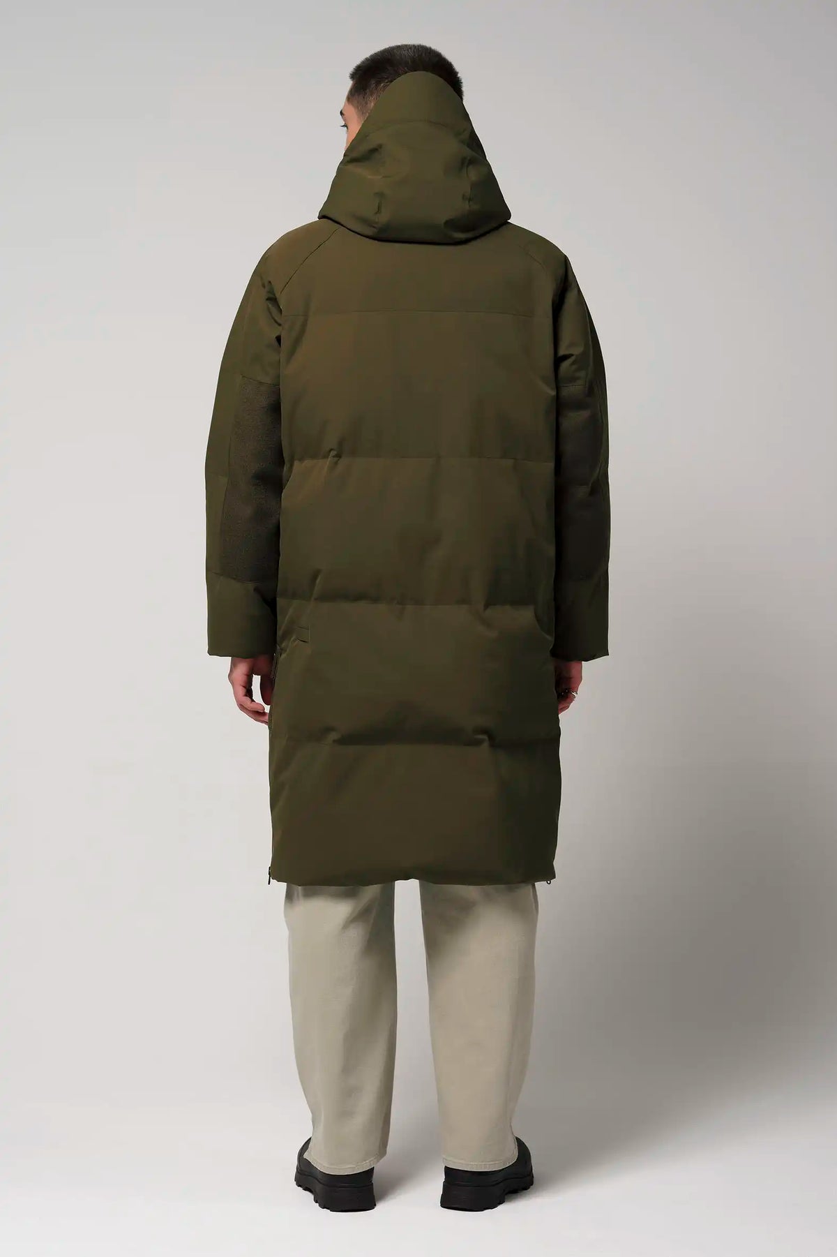 Back view of a man wearing the Barack Dark Olive Green Parka, showcasing its adjustable hood and warm design.