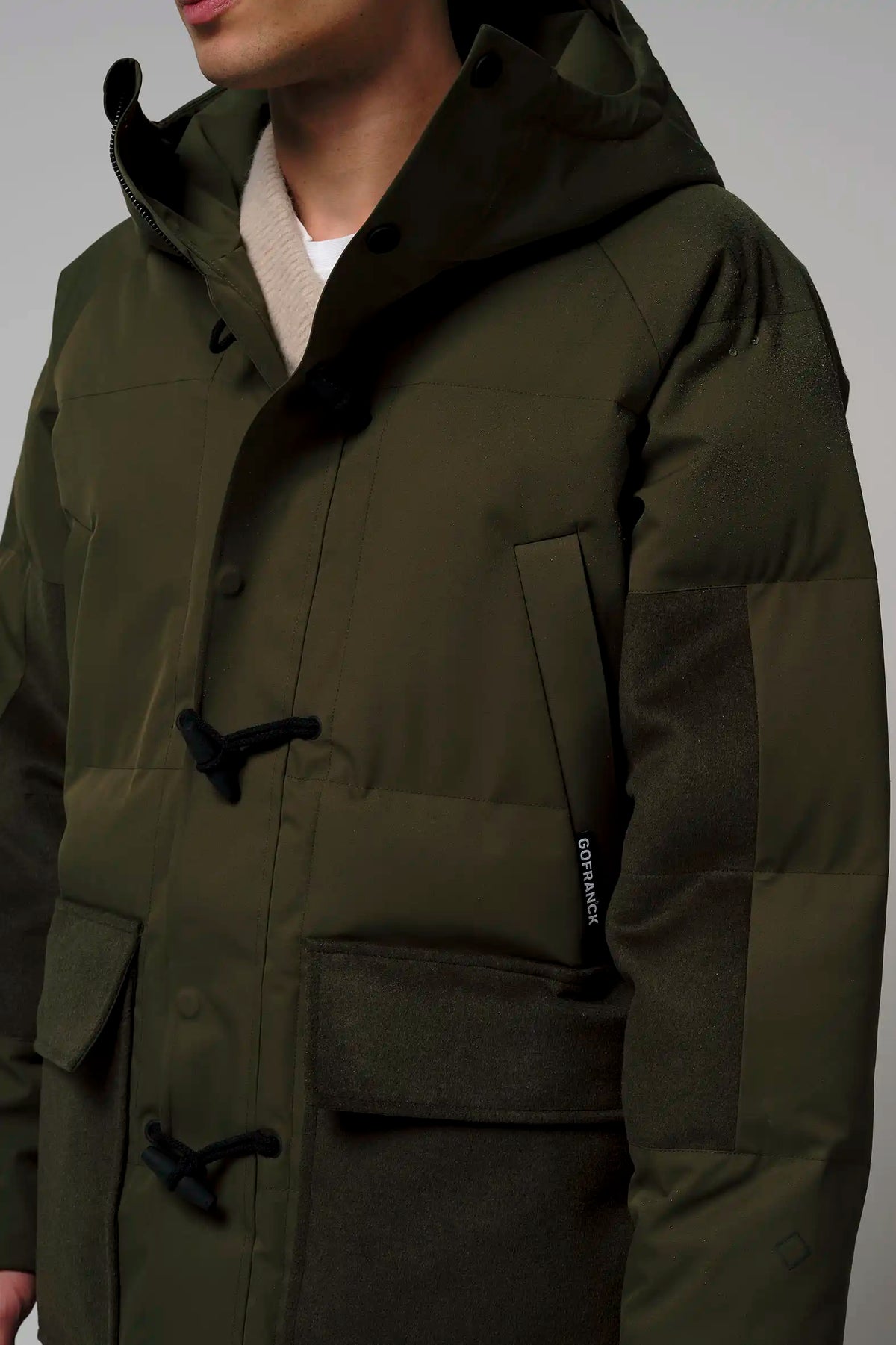 Barack Dark Olive Green Parka displayed on a model, showcasing its stylish design and functional features.