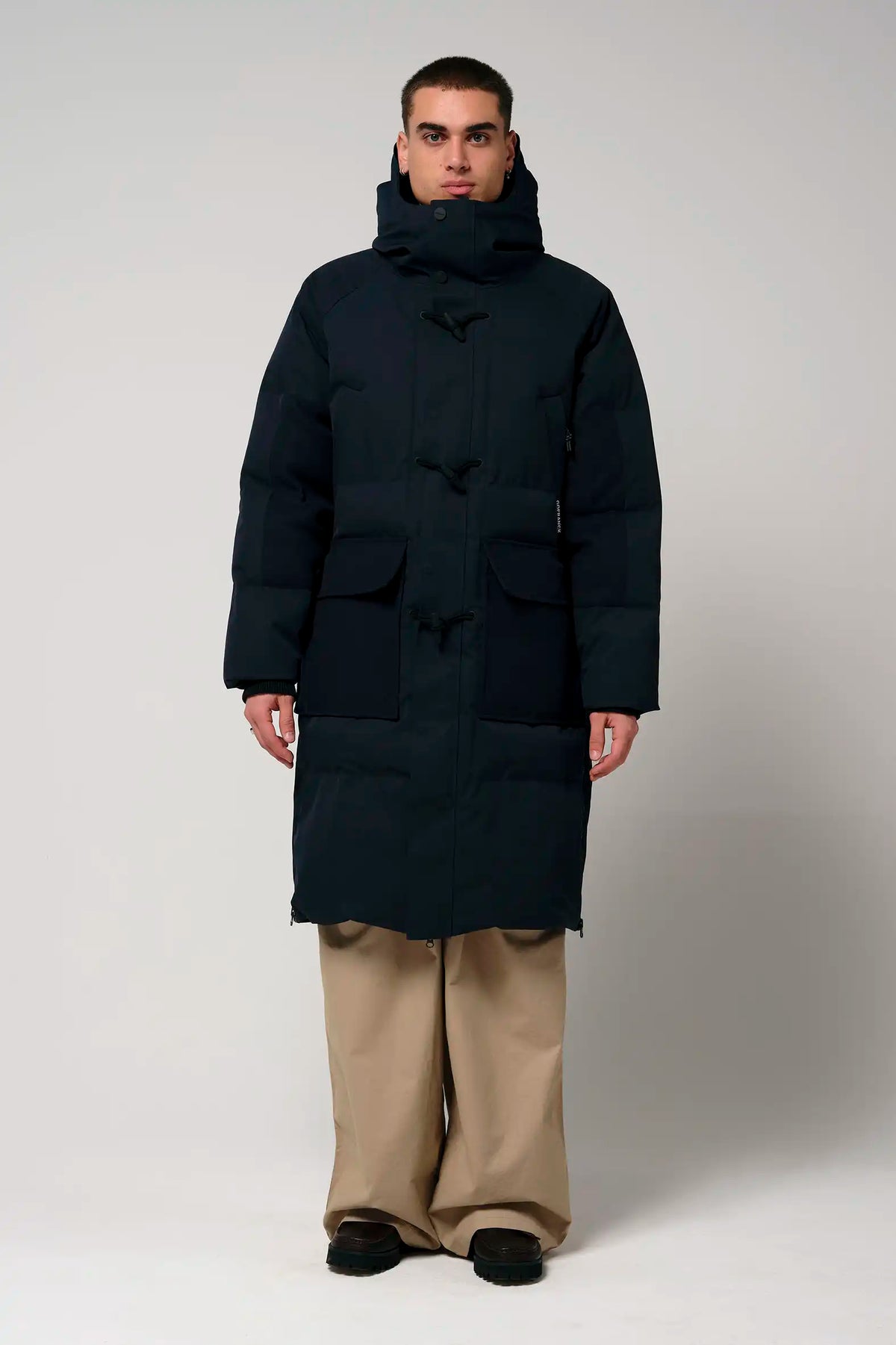 Barack Sky Captain Blue Parka shown in a model wearing a warm, waterproof coat with multiple pockets and an adjustable hood.