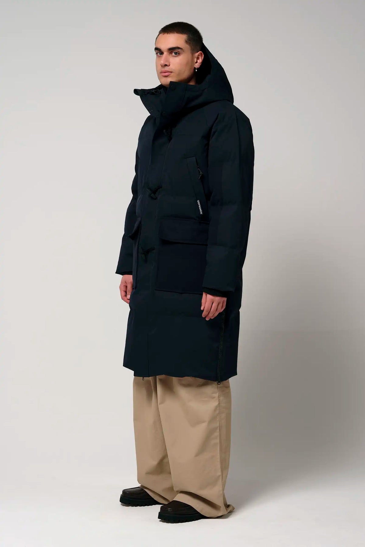 Man wearing a Barack Sky Captain Blue Parka, waterproof and windproof coat with adjustable hood and multiple pockets.