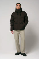 Bayu Black Coffee Coat worn by male model, showcasing waterproof and breathable design with puffer jacket style.