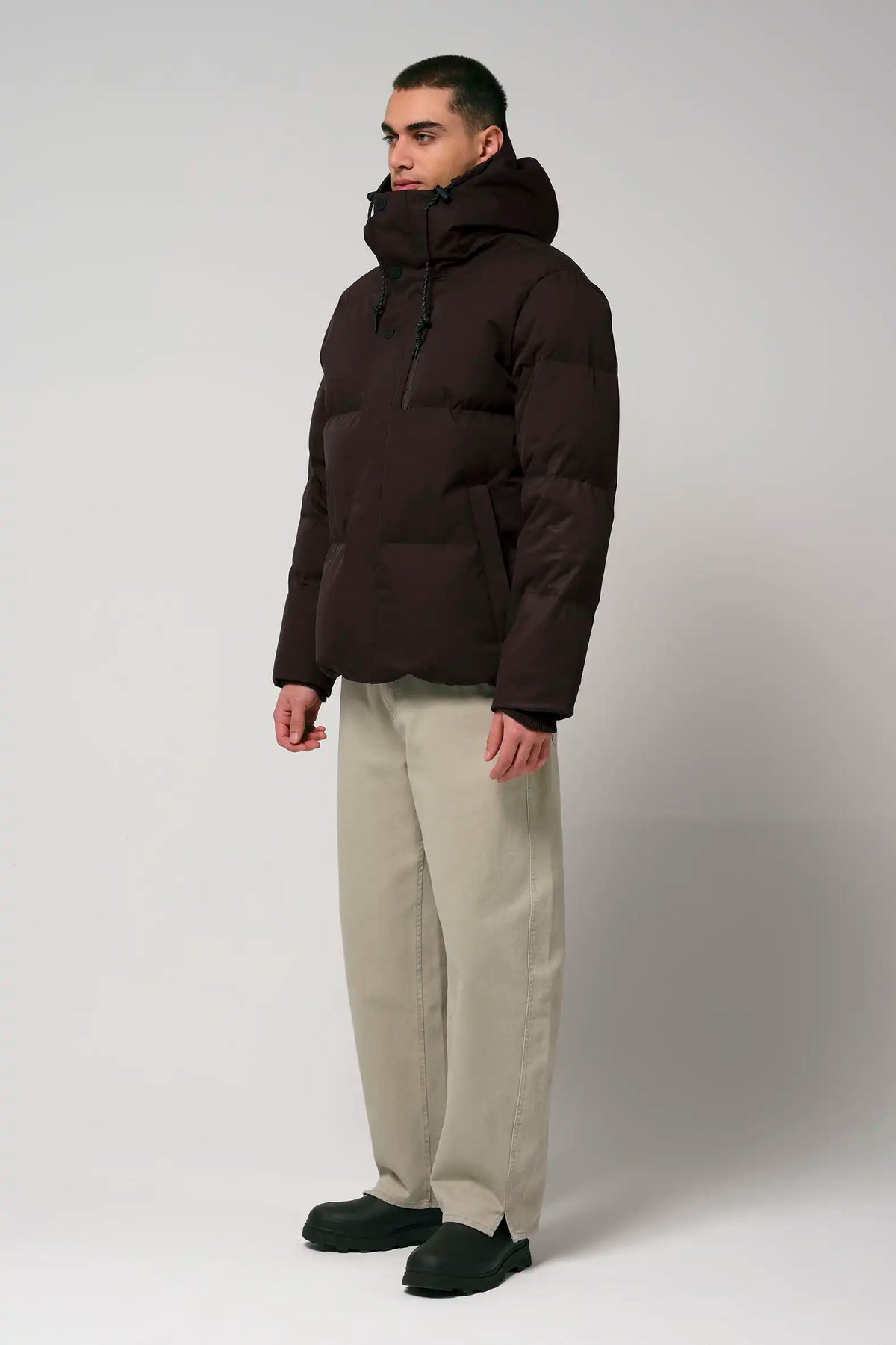 Model wearing the Bayu Black Coffee Coat, showcasing its stylish design and practical features.