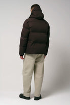 Model wearing the Bayu Black Coffee Coat, showcasing the back view of the waterproof puffer jacket in dark brown.