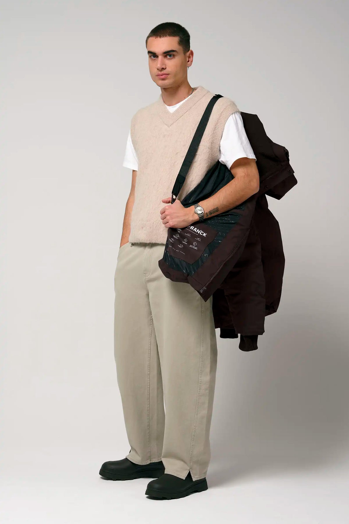Model wearing the Bayu Black Coffee Coat with neutral outfit, showcasing its style and versatility.