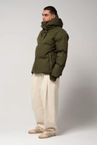 Model in Bayu Dark Olive Green Coat, showcasing its waterproof and breathable features.