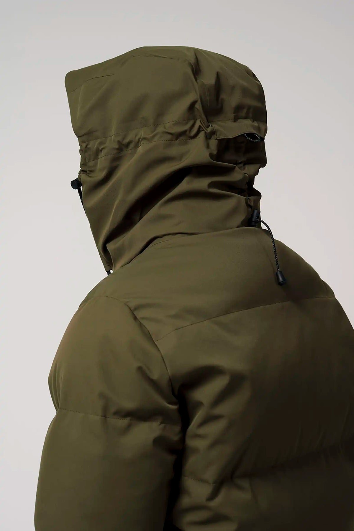 Bayu Dark Olive Green Coat featuring a hood and water-resistant design for weather protection.
