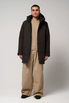 Model wearing the Cielo Black Coffee Coat with beige pants and a sweater.