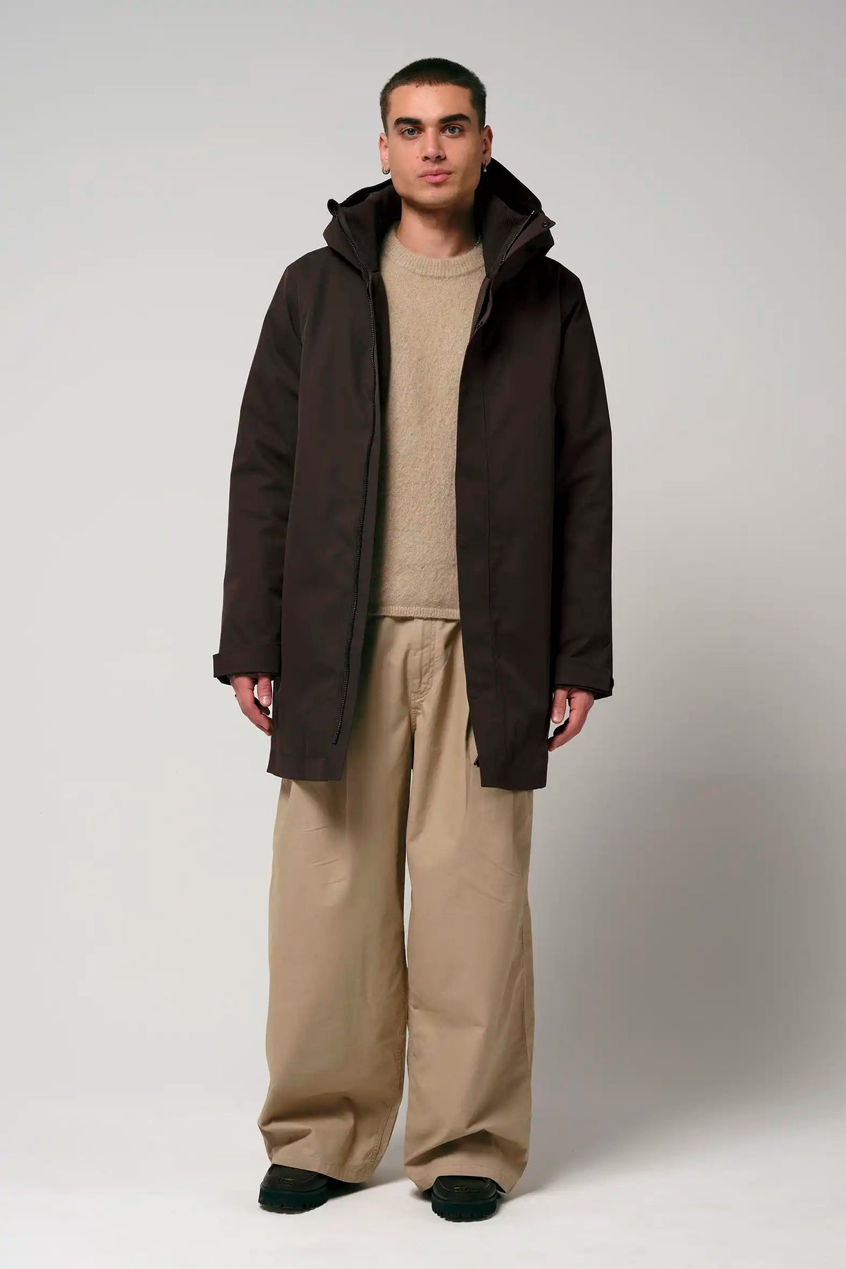 Model wearing the Cielo Black Coffee Coat with beige pants and a sweater.