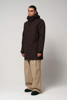 Model wearing the Cielo Black Coffee Coat in dark brown with a modern fit and functional design.