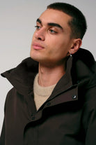 Cielo Black Coffee Coat model wearing brown coat with hood and neutral sweater.