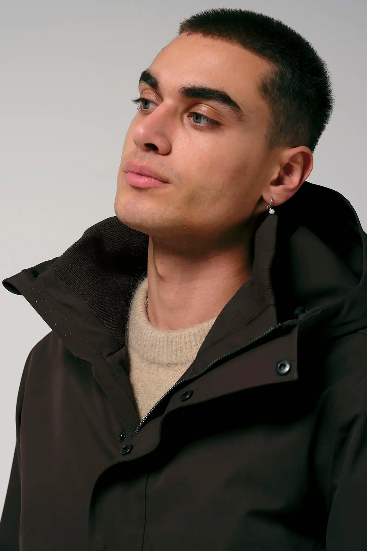Cielo Black Coffee Coat model wearing brown coat with hood and neutral sweater.