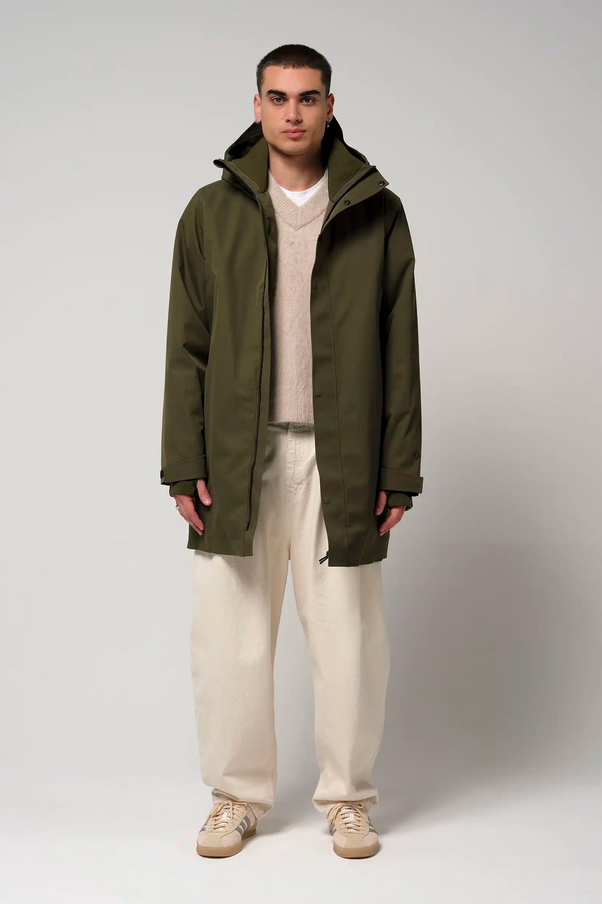 Model wearing Cielo Dark Olive Green Coat, showcasing its waterproof and breathable features.