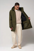 Cielo Dark Olive Green Coat worn by a model, showcasing its waterproof and stylish design.
