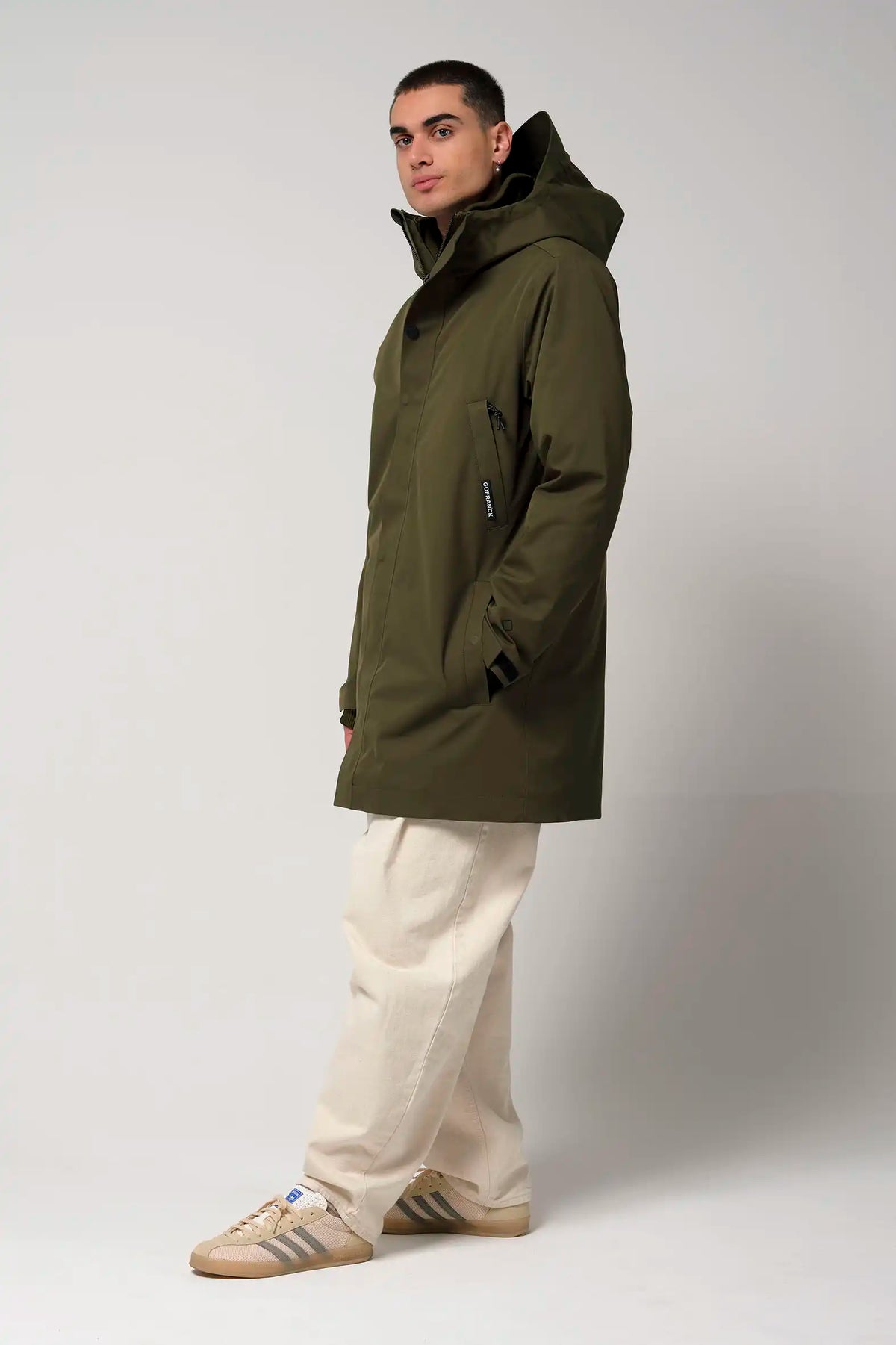 Cielo Dark Olive Green Coat worn by model, showcasing waterproof and breathable features with a stylish design.