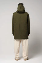 Model wearing the Cielo Dark Olive Green Coat from the back, showcasing its waterproof fabric and hood.
