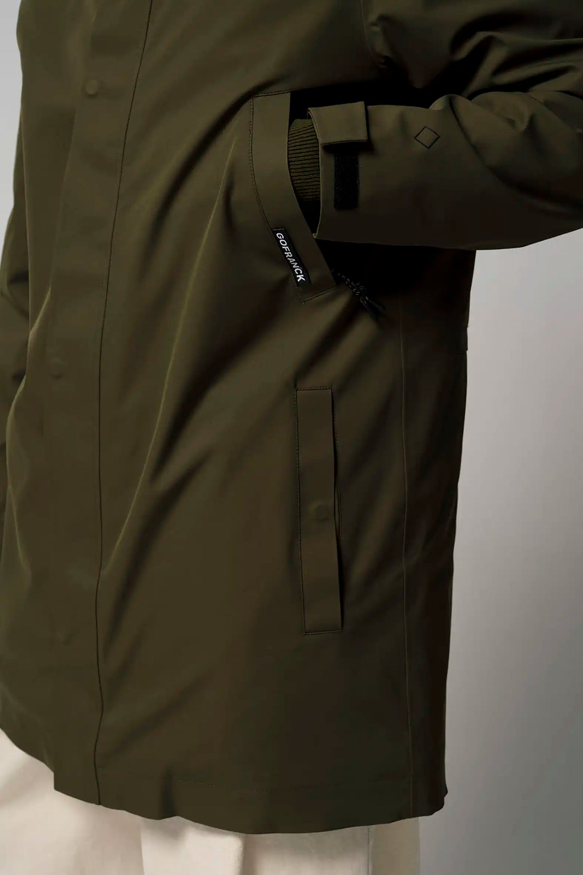 Cielo Dark Olive Green Coat detail showing waterproof fabric and stylish design features.