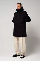 Model wearing the Cielo Deep Black Coat, showcasing its waterproof and windproof features.