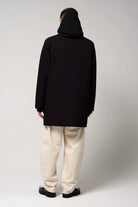 Model wearing the Cielo Deep Black Coat from the back, showcasing its waterproof and windproof features.