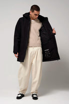 Model wearing Cielo Deep Black Coat, showcasing the interior features and stylish fit.