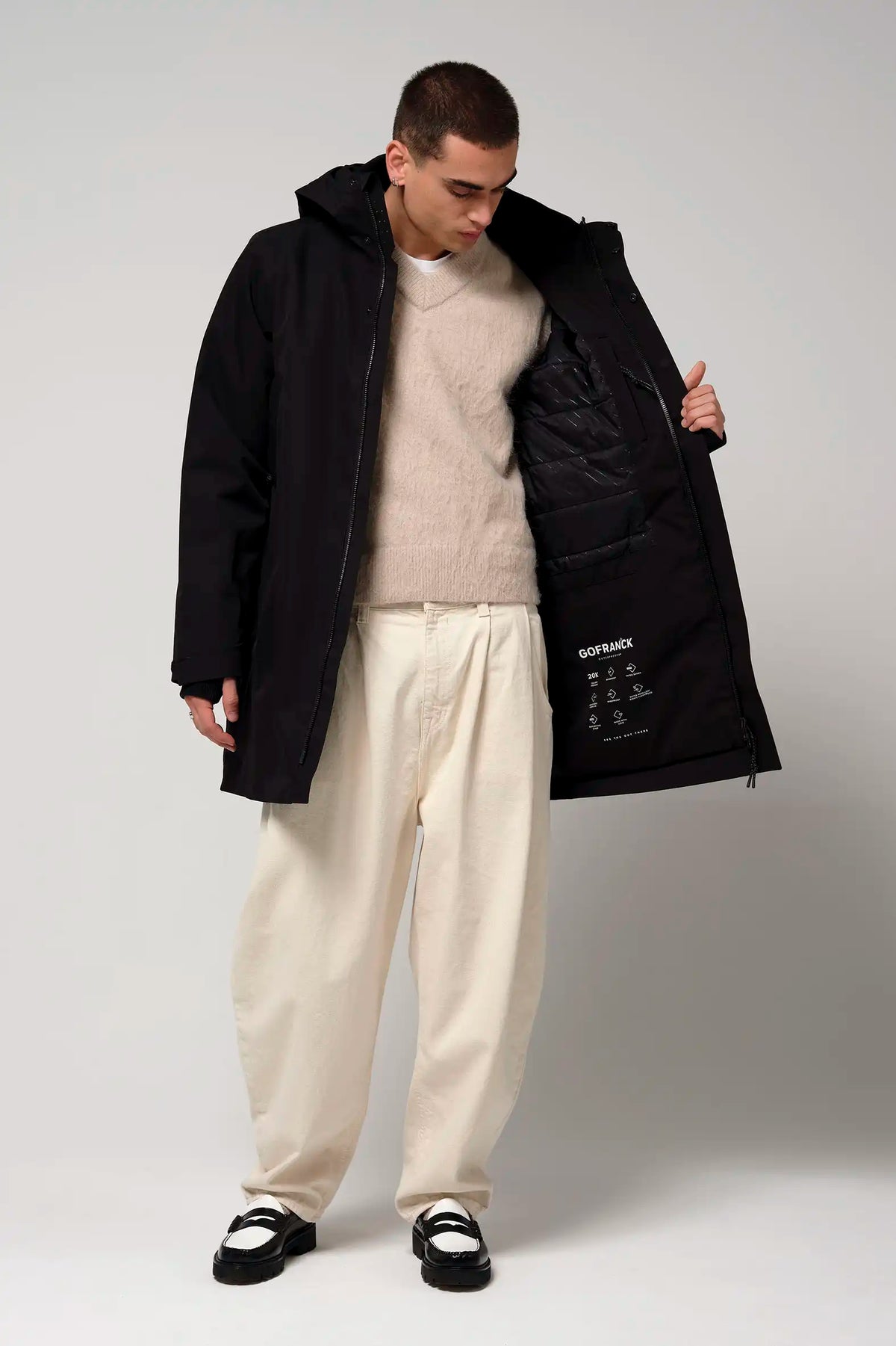 Model wearing Cielo Deep Black Coat, showcasing the interior features and stylish fit.