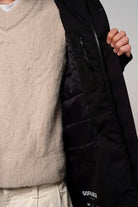 Cielo Deep Black Coat featuring a cozy inner lining and functional pockets, ideal for chilly weather.