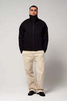 Claud Deep Black Coat on a model, showcasing a stylish, waterproof 3-in-1 jacket suitable for fall and winter.