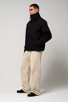 Claud Deep Black Coat worn by a model, showcasing its stylish design and functionality in a neutral background.