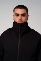 Model wearing the Claud Deep Black Coat showcasing its high collar and sleek design.