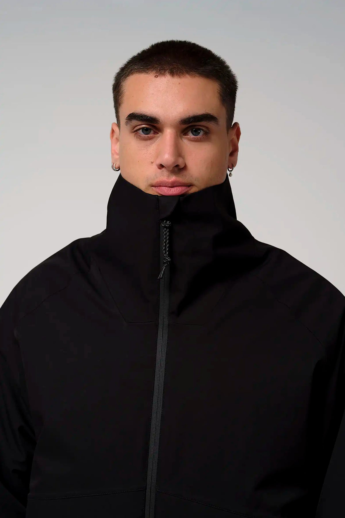 Model wearing the Claud Deep Black Coat showcasing its high collar and sleek design.