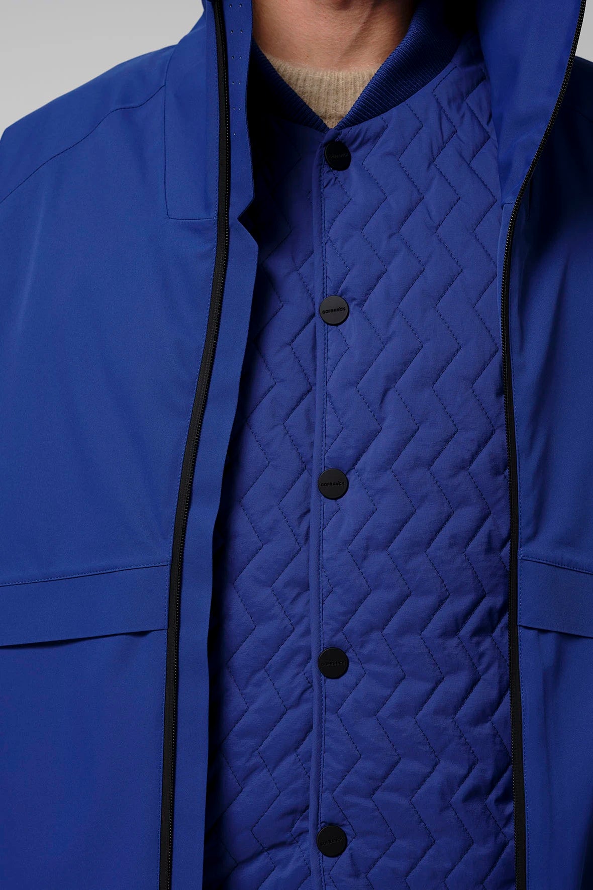Claud Sodalite Blue Coat featuring a blue outer layer and a quilted inner jacket for warmth and style.