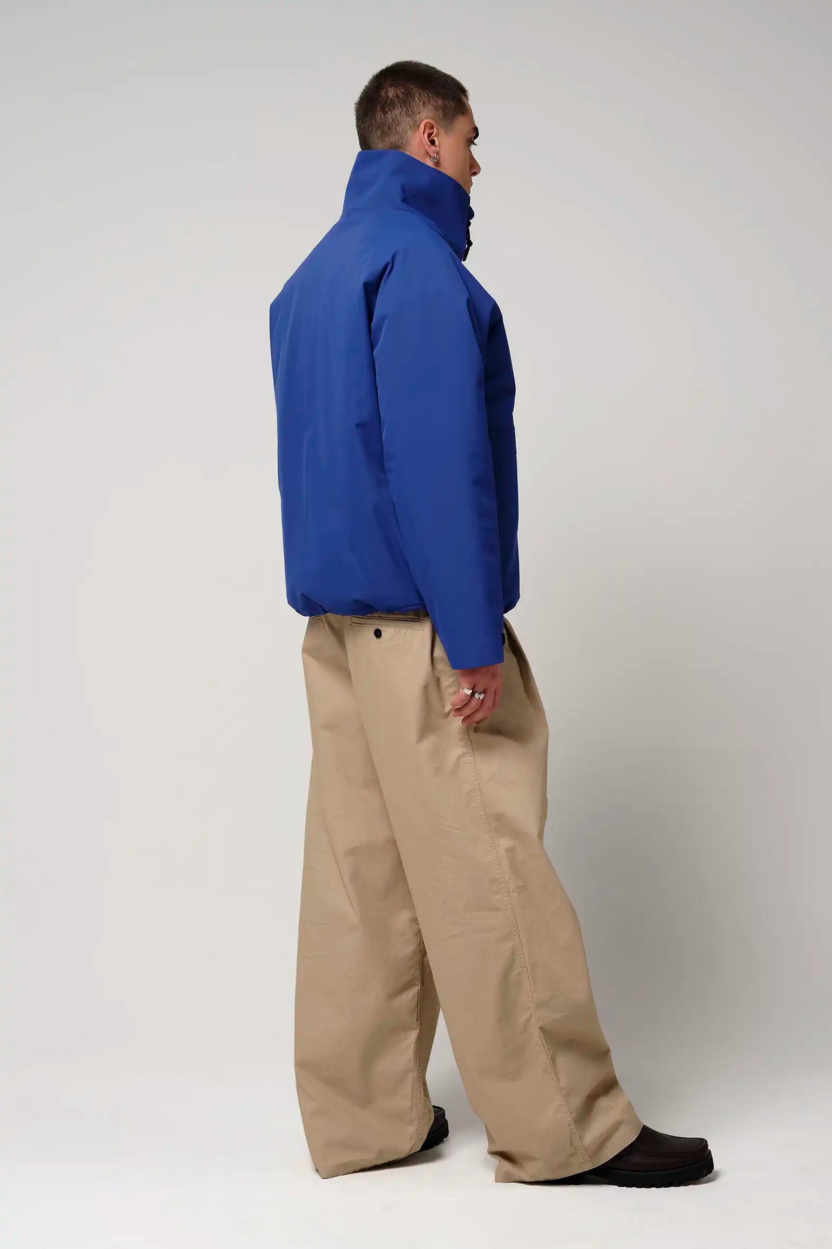 Claud Sodalite Blue Coat displayed in a side view, showcasing its waterproof design and modern fit.